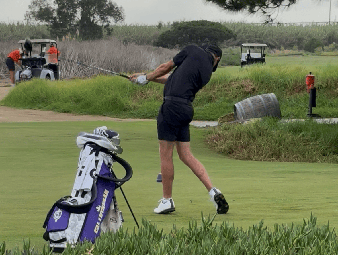 Junior golfer hitting a tee shot during a tournament round.